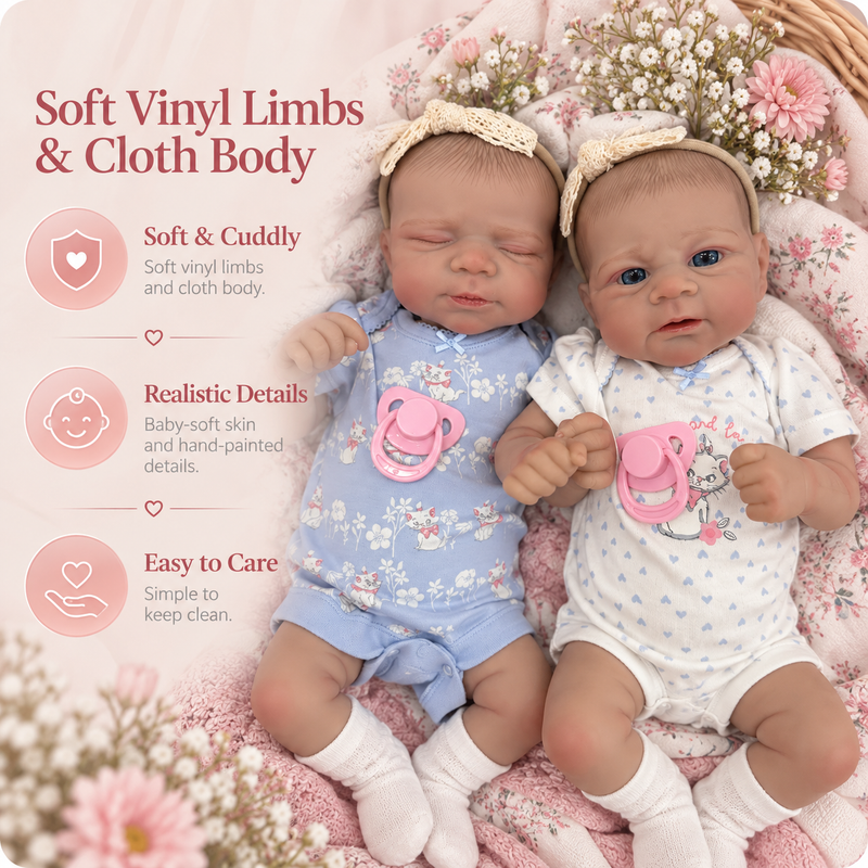 Two realistic baby doll twins with soft vinyl limbs and cloth bodies, dressed in floral baby outfits and lying on a pink floral blanket. Text on the left highlights soft vinyl limbs, cloth bodies, realistic details, and easy care.